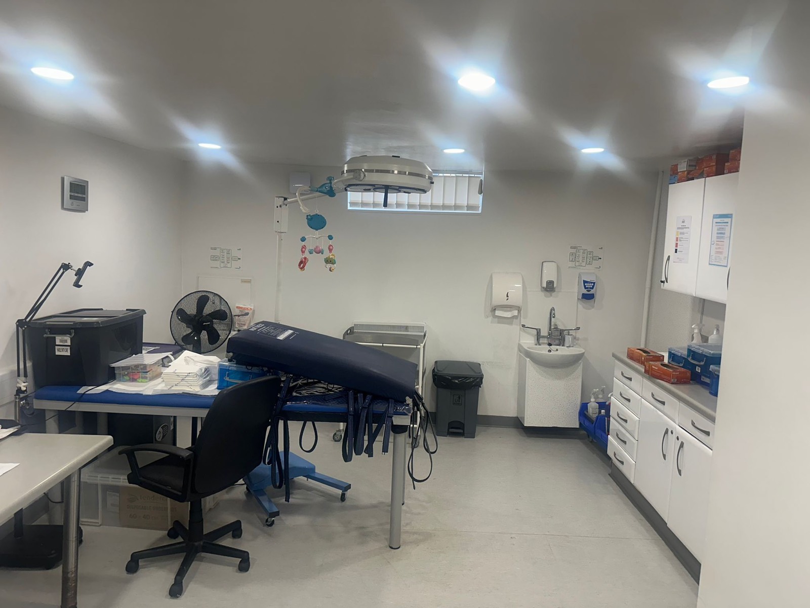 Downstairs operating theatre with surgical light, couch and sink