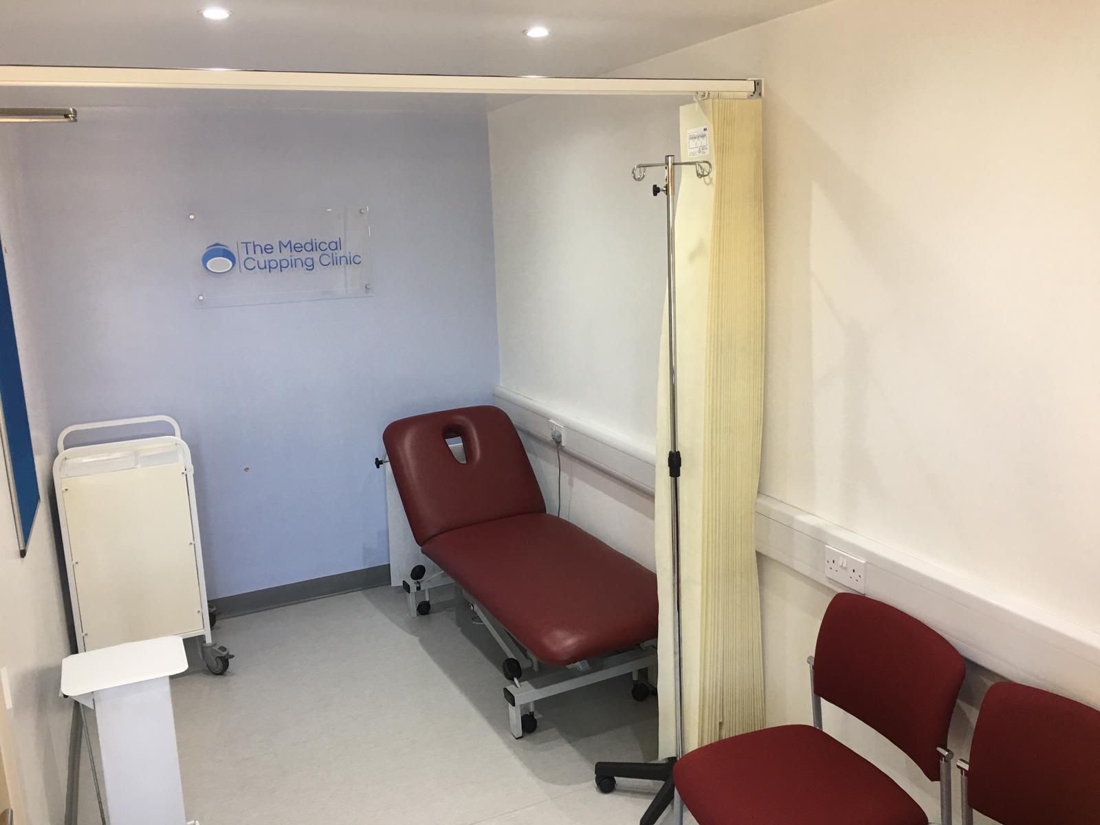 Treatment room with examination couch and privacy curtain